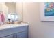 Bathroom vanity with modern fixtures, a mosaic backsplash, and a large mirror at 2870 W Parkside Pl, Denver, CO 80221