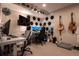 Comfortable bedroom featuring dual monitors, hexagon sound dampeners, and decorated with guitars and hats at 2870 W Parkside Pl, Denver, CO 80221