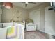 Charming Bedroom featuring a crib, armchair, neutral wall colors, and a ceiling fan at 2870 W Parkside Pl, Denver, CO 80221