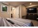 Bedroom featuring a large television, dresser, and neutral color palette at 2870 W Parkside Pl, Denver, CO 80221