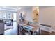 Dining area featuring a wooden table with seating, opening to the living room and staircase at 2870 W Parkside Pl, Denver, CO 80221