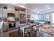 Eat-in kitchen featuring gray cabinets, stainless steel appliances, and an open view to the living room at 2870 W Parkside Pl, Denver, CO 80221