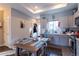 Kitchen and dining area with gray cabinets, stainless appliances, and a wooden dining table at 2870 W Parkside Pl, Denver, CO 80221