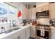 Well-lit kitchen with stainless steel appliances, white countertops, and subway tile backsplash at 2870 W Parkside Pl, Denver, CO 80221