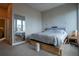 Spacious bedroom with a queen-sized bed, a large mirror, and natural light from the windows at 2870 W Parkside Pl, Denver, CO 80221