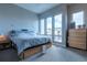 Serene main bedroom with large windows, a comfortable bed, and modern furnishings at 2870 W Parkside Pl, Denver, CO 80221