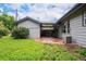 The backyard offers a lush lawn, stone patio, mature landscaping, and a covered outdoor space at 1694 S Elm St, Denver, CO 80222