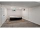 Unfinished basement space featuring neutral carpet, white walls, and small window for natural light at 1694 S Elm St, Denver, CO 80222