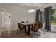 Dining room with a modern light fixture and view of the outdoors from a large window at 1694 S Elm St, Denver, CO 80222