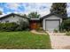 Charming home with an attractive front yard, stone path, mature landscaping, and a detached garage at 1694 S Elm St, Denver, CO 80222