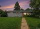 Charming single-story home with a well-manicured lawn and inviting walkway at sunset at 1694 S Elm St, Denver, CO 80222