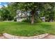 Spacious front yard with a large tree providing ample shade to the home at 1694 S Elm St, Denver, CO 80222