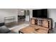 Open-concept living area featuring wood floors and a modern entertainment center at 1694 S Elm St, Denver, CO 80222