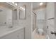 Bright bathroom featuring floral wallpaper, vanity and shower at 2682 S Benton St, Lakewood, CO 80227