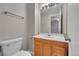 Bathroom with wood vanity, large mirror, and medicine cabinet at 2682 S Benton St, Lakewood, CO 80227