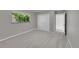 Bedroom featuring neutral carpet, light gray walls and large window at 2682 S Benton St, Lakewood, CO 80227