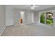 Spacious bedroom with neutral carpet, built-in shelving, and sliding glass door to backyard at 2682 S Benton St, Lakewood, CO 80227