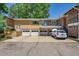 Multi-Gathering brick home with garage parking and balcony on a sunny day at 2682 S Benton St, Lakewood, CO 80227
