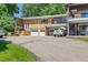 Multi-Gathering brick home with garage parking and balcony on a sunny day at 2682 S Benton St, Lakewood, CO 80227