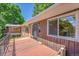 Inviting front porch with wood floors, perfect for relaxing outdoors in this charming home at 2682 S Benton St, Lakewood, CO 80227