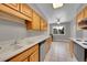 Functional kitchen features tiled floor, light wood cabinets, and modern appliances at 2682 S Benton St, Lakewood, CO 80227