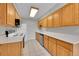 Efficient kitchen with tiled floors, stainless steel appliances, and light wood cabinetry at 2682 S Benton St, Lakewood, CO 80227