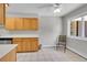 Bright kitchen featuring light wood cabinets, stainless steel dishwasher and tile flooring at 2682 S Benton St, Lakewood, CO 80227