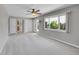 Well-lit living room with large windows, neutral walls, and plush gray carpet at 2682 S Benton St, Lakewood, CO 80227