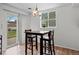 A bright dining area with a modern table set and sliding glass door at 3021 S Ursula Cir # 102, Aurora, CO 80014