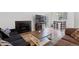 Open-concept living space with fireplace, sofas, dining table, and bright natural light at 3021 S Ursula Cir # 102, Aurora, CO 80014