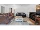 Inviting living room with comfortable seating, a cozy fireplace, and neutral decor at 3021 S Ursula Cir # 102, Aurora, CO 80014