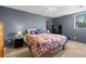 Comfortable bedroom features plush bedding, neutral wall color, and carpet flooring at 3021 S Ursula Cir # 102, Aurora, CO 80014