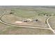 Expansive lot featuring a circular drive and luxurious home with multiple outbuildings and a riding arena at 7600 Patrick Trl, Elizabeth, CO 80107