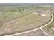 Sprawling land with a winding road, dotted with houses in the distance, and green spaces at 7600 Patrick Trl, Elizabeth, CO 80107