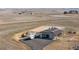 Aerial view of the property showcasing the barn, riding arena, trailer, and expansive land at 7600 Patrick Trl, Elizabeth, CO 80107