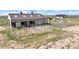 Exterior image of horse barn with white fencing and green pasture in view at 7600 Patrick Trl, Elizabeth, CO 80107