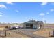 Large horse barn featuring multiple stalls, a well-maintained exterior, and ample parking space for vehicles and trailers at 7600 Patrick Trl, Elizabeth, CO 80107