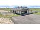 Horse barn exterior view with metal fencing, gravel parking area, and green pasture at 7600 Patrick Trl, Elizabeth, CO 80107