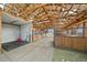 Spacious barn interior featuring multiple horse stalls with wooden accents and concrete flooring at 7600 Patrick Trl, Elizabeth, CO 80107