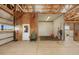 Barn interior showcasing wooden stalls, concrete floors, and high ceilings at 7600 Patrick Trl, Elizabeth, CO 80107