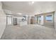 Spacious finished basement area with a partial kitchen, large carpeted area, and natural light at 7600 Patrick Trl, Elizabeth, CO 80107