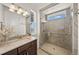 Bathroom featuring marble countertop vanity, shower and light fixture at 7600 Patrick Trl, Elizabeth, CO 80107