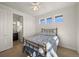 Bedroom with light-colored walls, a metal bed frame, and natural light from the windows at 7600 Patrick Trl, Elizabeth, CO 80107