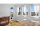 Bright bedroom with multiple windows showcasing a scenic view and a private balcony at 7600 Patrick Trl, Elizabeth, CO 80107