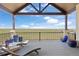 Large outdoor deck with scenic views, lounge chairs, and colorful flower pots at 7600 Patrick Trl, Elizabeth, CO 80107