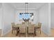 Well-lit dining room with a wooden table, wicker chairs, and a modern chandelier at 7600 Patrick Trl, Elizabeth, CO 80107
