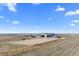 Wide shot of equestrian arena, stables, and beautiful countryside views at 7600 Patrick Trl, Elizabeth, CO 80107
