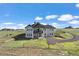 Back of home featuring a covered deck with a large manicured backyard at 7600 Patrick Trl, Elizabeth, CO 80107