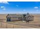 Stunning stucco home with a circular driveway and a horse statue on a vast, open landscape at 7600 Patrick Trl, Elizabeth, CO 80107