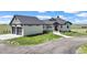 Charming home featuring an attached two-car garage, gray roof, and an expansive front yard at 7600 Patrick Trl, Elizabeth, CO 80107